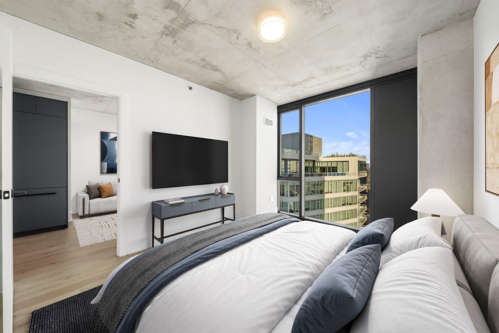 234 West Polk Street, Unit 3411 Chicago, IL 60607 - Photo 4 of 37 a bedroom with a large bed and a flat screen tv