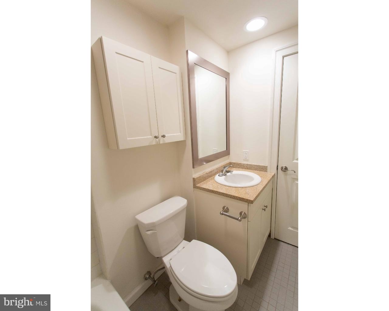 1100 Spruce Street, Unit 2B Philadelphia, PA 19107 - Photo 16 of 22 a bathroom with a toilet a sink and a mirror