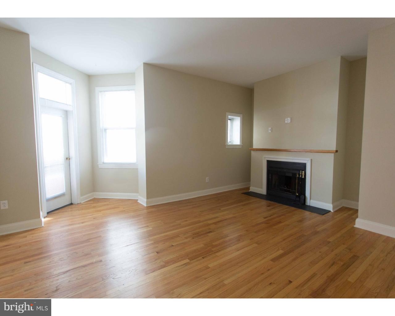 1100 Spruce Street, Unit 2B Philadelphia, PA 19107 - Photo 3 of 22 a view of empty room with wooden floor and fireplace