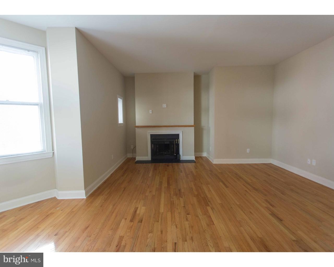 1100 Spruce Street, Unit 2B Philadelphia, PA 19107 - Photo 4 of 22 a view of empty room with wooden floor and fireplace