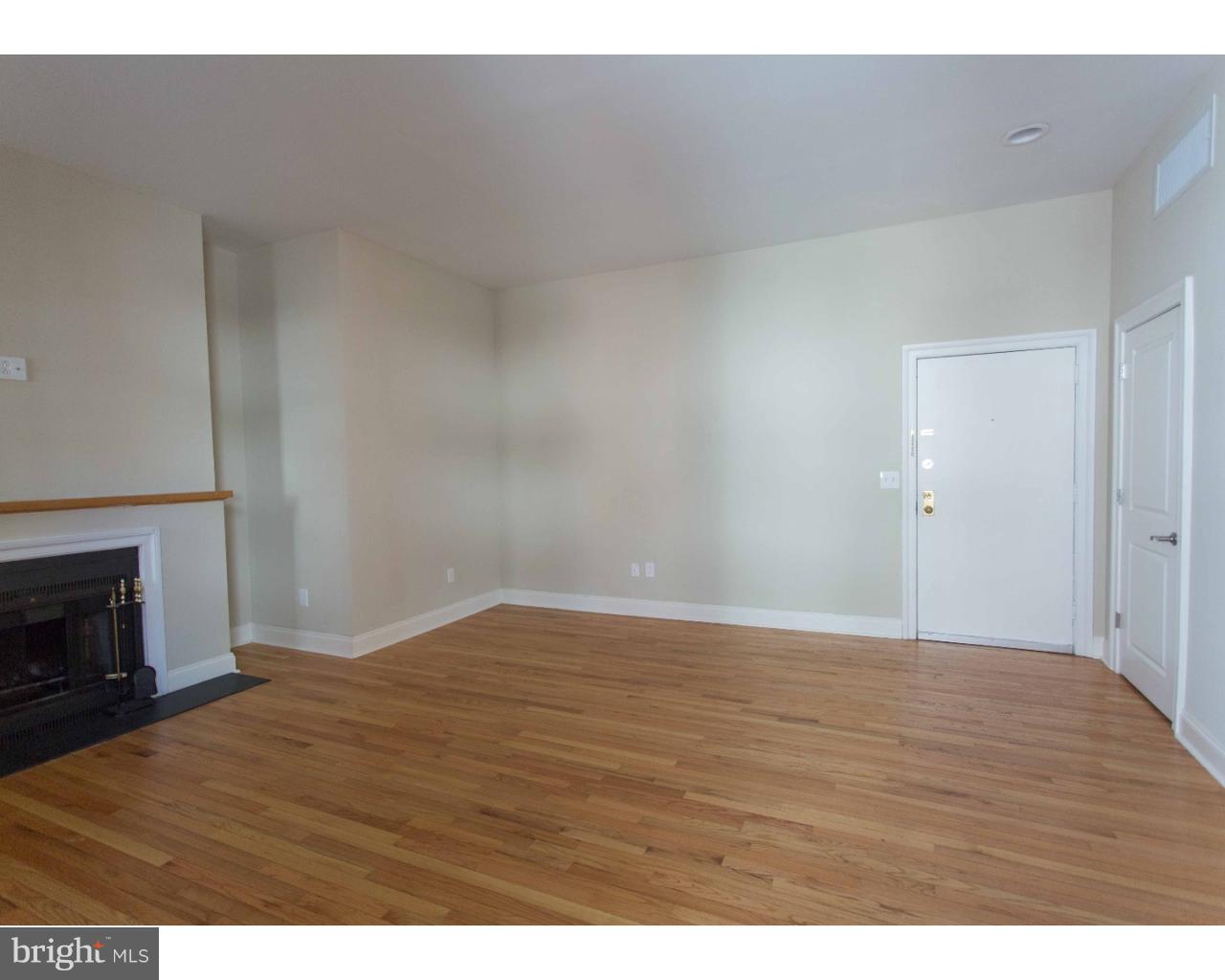 1100 Spruce Street, Unit 2B Philadelphia, PA 19107 - Photo 5 of 22 a view of empty room with wooden floor and fireplace