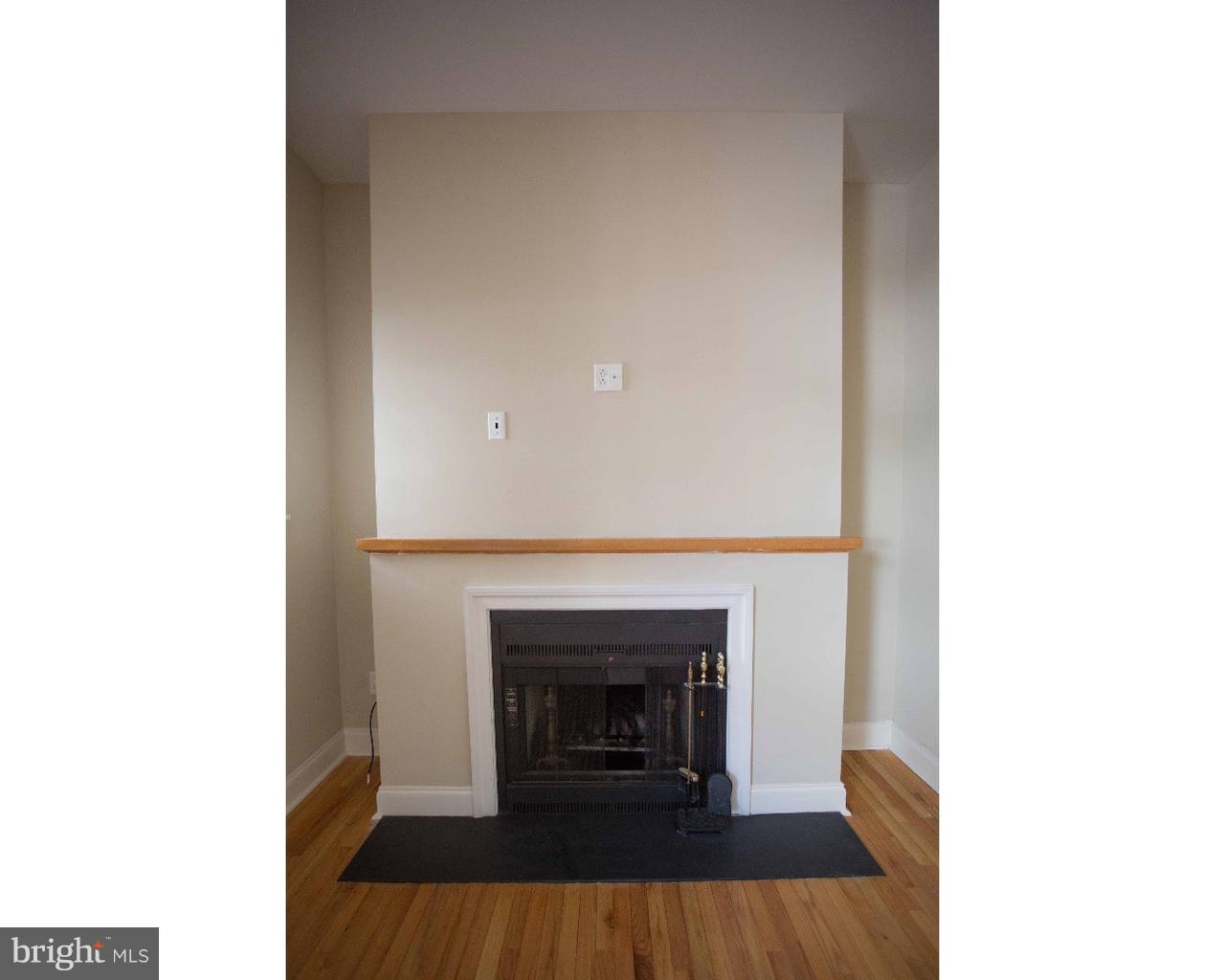1100 Spruce Street, Unit 2B Philadelphia, PA 19107 - Photo 6 of 22 a view of a livingroom with a fireplace and a fireplace