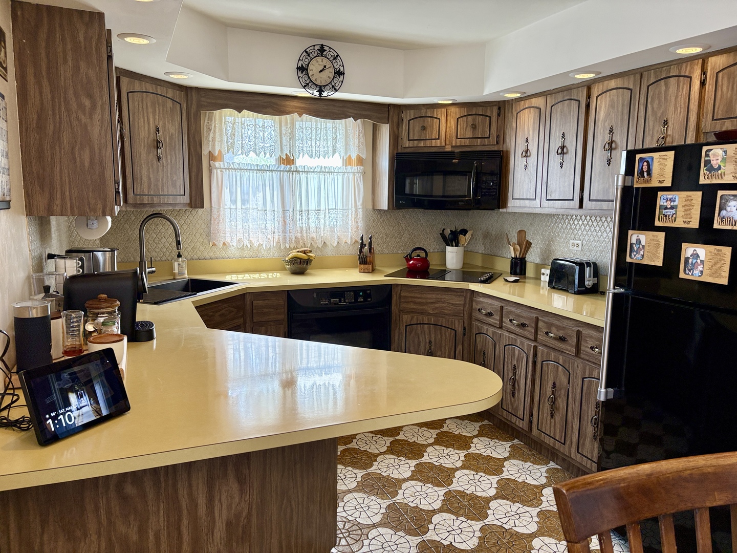 5600 St Charles Road Berkeley, IL 60163 - Photo 12 of 25 a kitchen with stainless steel appliances a sink a stove a microwave cabinets and a window