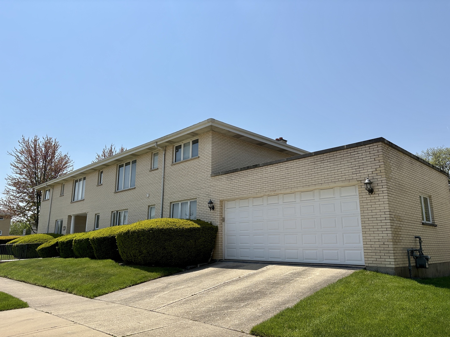 5600 St Charles Road Berkeley, IL 60163 - Photo 3 of 25 a front view of a house with a garden and yard