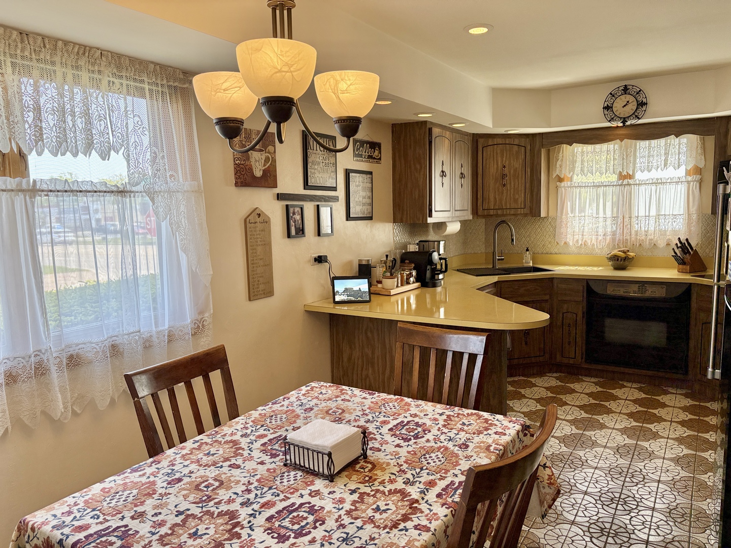 5600 St Charles Road Berkeley, IL 60163 - Photo 10 of 25 a kitchen with a table chairs sink and cabinets