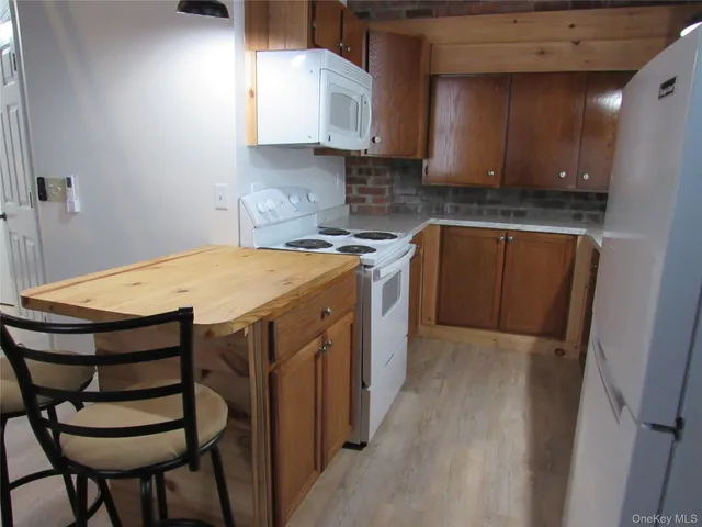 a view of hall way with furniture and stairs