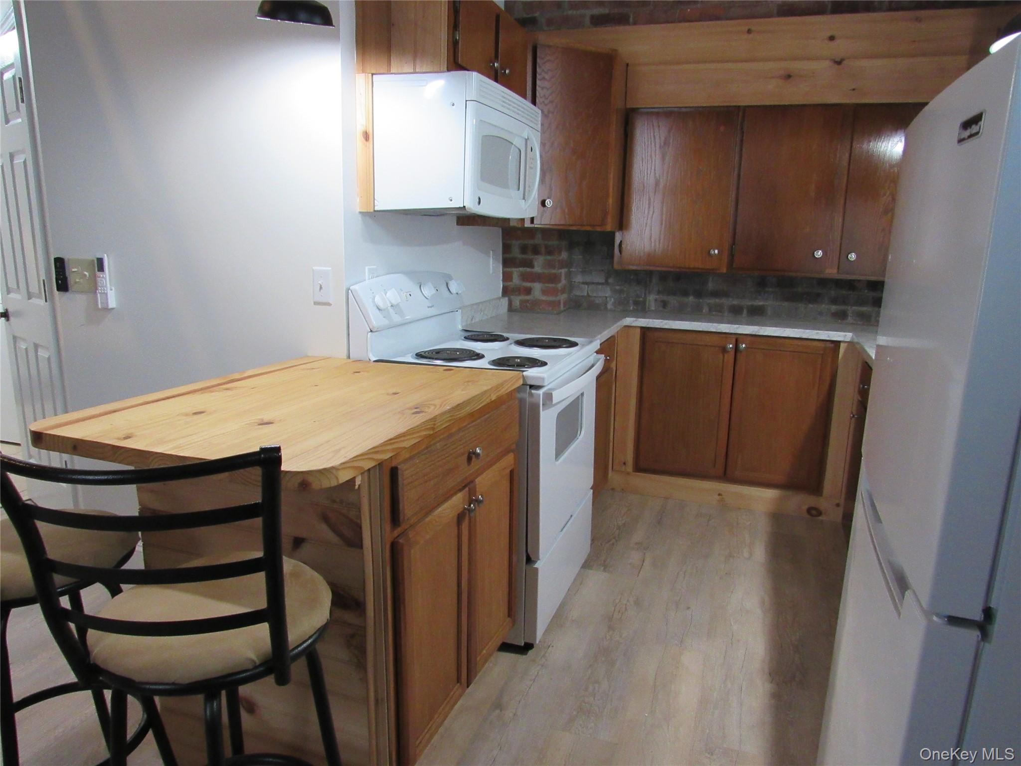 76 Webster Avenue Goshen, NY 10924 - Photo 4 of 15 a kitchen with a stove a sink and cabinets