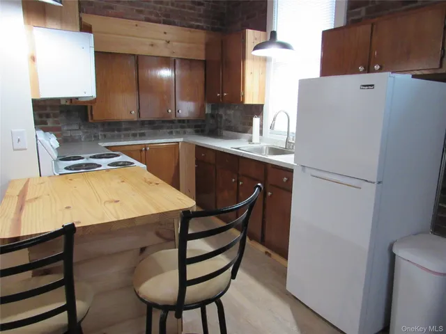 a kitchen with a sink a stove and cabinets