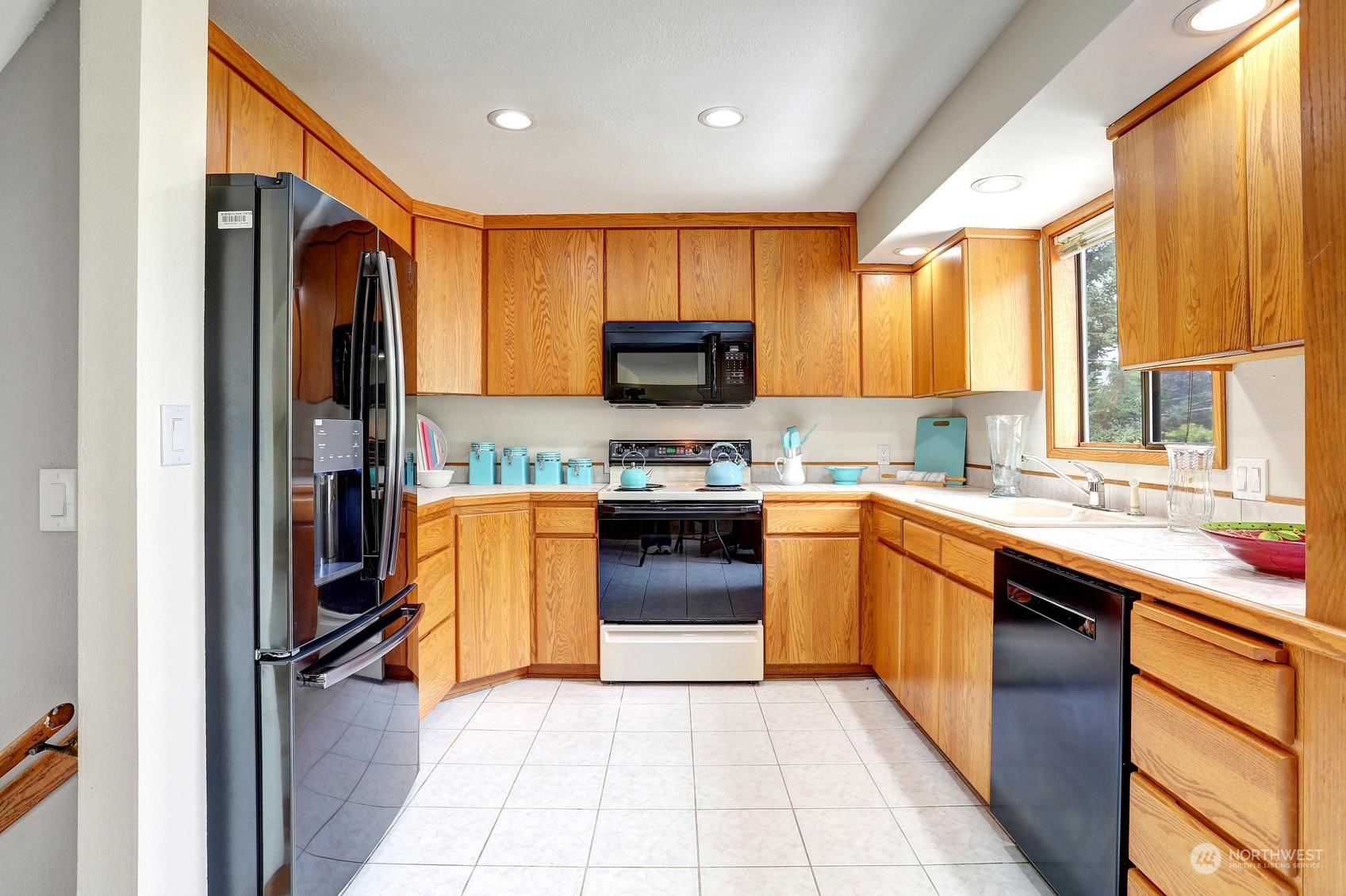 237 South 197th Street Des Moines, WA 98148 - Photo 8 of 29 a kitchen with stainless steel appliances granite countertop a stove top oven a sink and a refrigerator