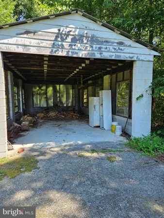 a view of a patio with table and chairs under an umbrella