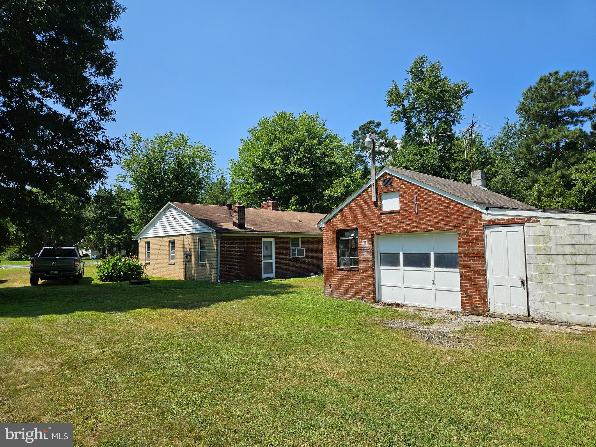16485 Dawn Boulevard Hanover, VA 23069 - Photo 7 of 29 a front view of a house with a garden and trees