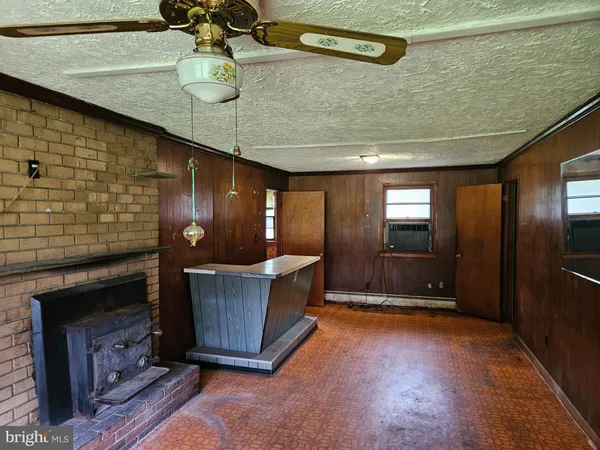 a room with fireplace and cabinets