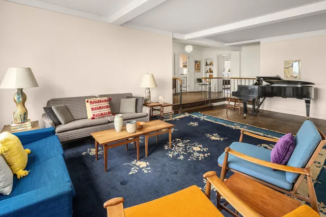 a view of a livingroom with furniture and hardwood floor