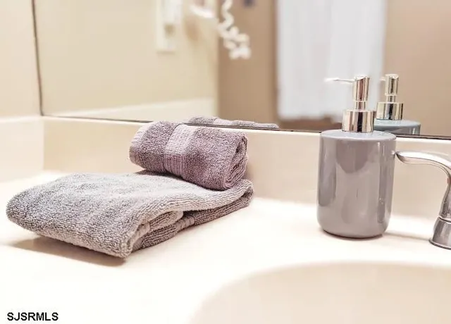 a bedroom with a bed a couch and a mirror