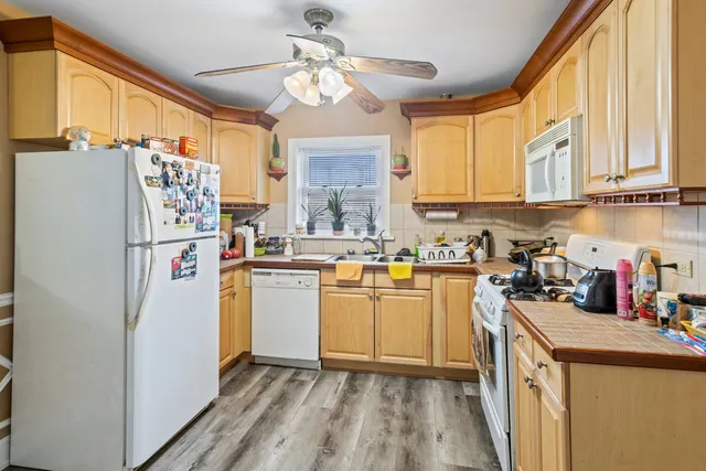 a kitchen with refrigerator cabinets and wooden floor
