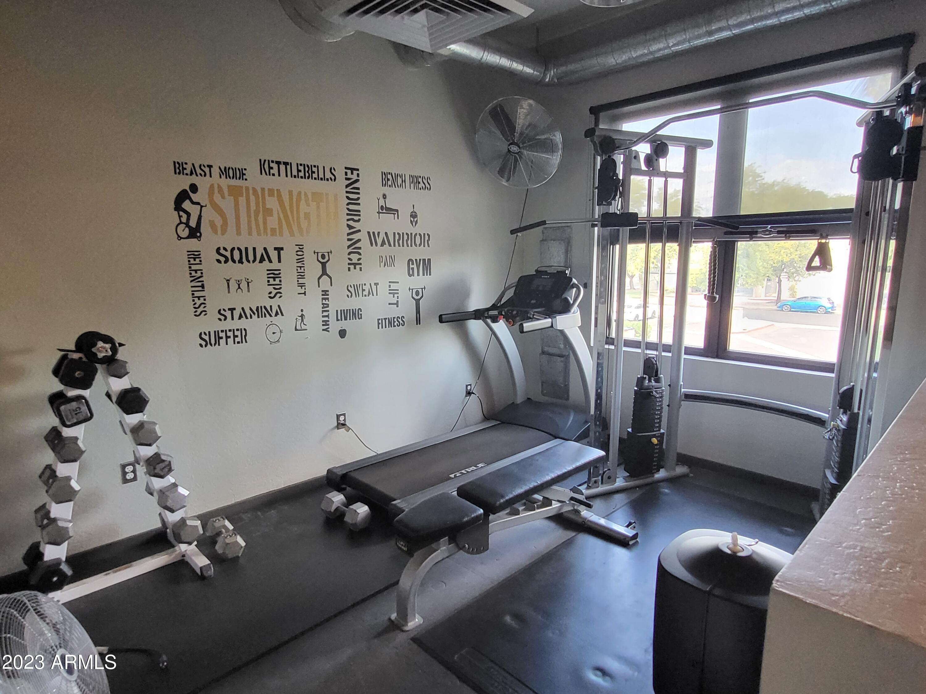 914 East Osborn Road, Unit 218 Phoenix, AZ 85014 - Photo 22 of 30 a room with gym equipment and a large window