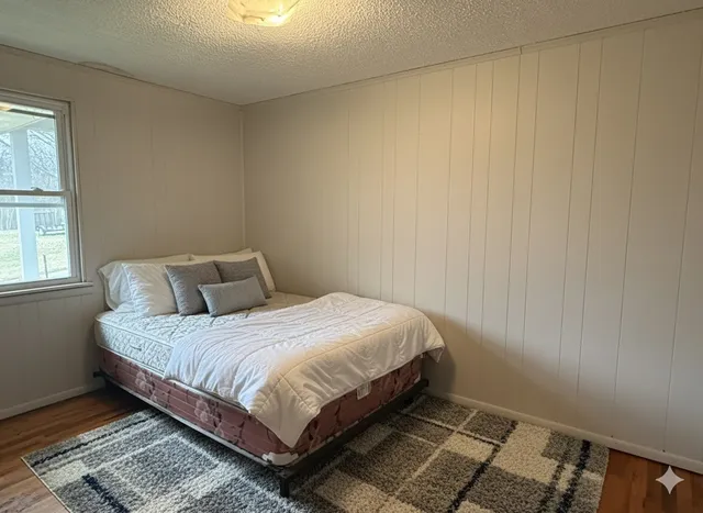 a bedroom with a bed and window