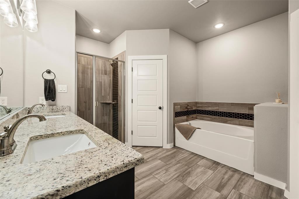 1034 Antelope Trail Temple, TX 76504 - Photo 12 of 24 a bathroom with a granite countertop sink and a bathtub