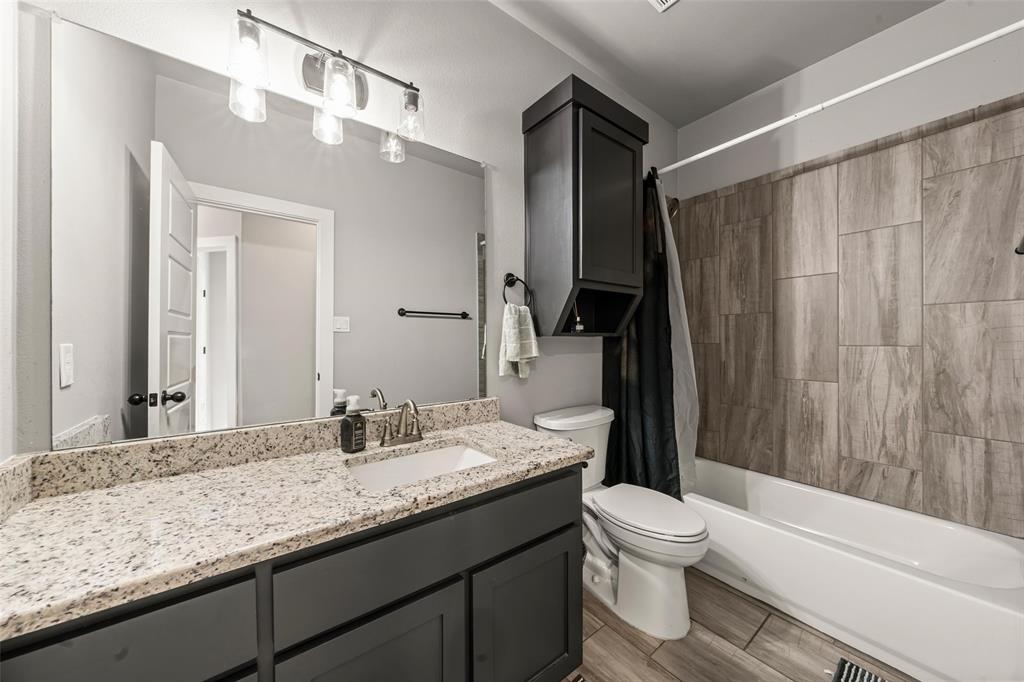 1034 Antelope Trail Temple, TX 76504 - Photo 18 of 24 a bathroom with a granite countertop sink toilet and shower