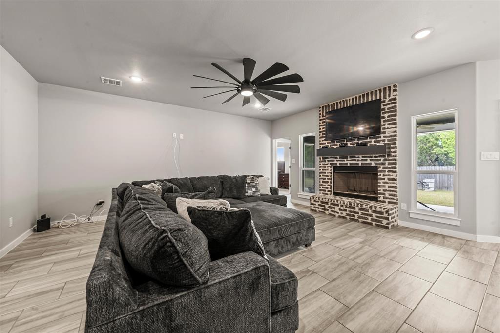 1034 Antelope Trail Temple, TX 76504 - Photo 2 of 24 a living room with furniture a flat screen tv and a fireplace