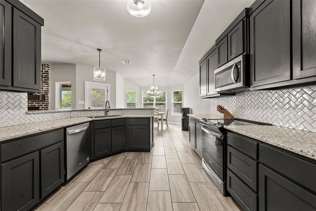 1034 Antelope Trail Temple, TX 76504 - Photo 8 of 24 a kitchen with stainless steel appliances granite countertop a sink counter space and cabinets