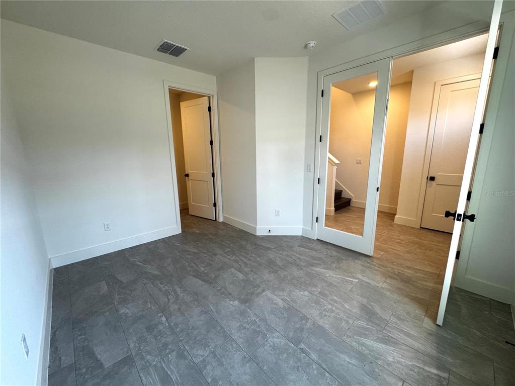 15250 Groveside Road Winter Garden, FL 34787 - Photo 3 of 15 an empty room with wooden floor and a window
