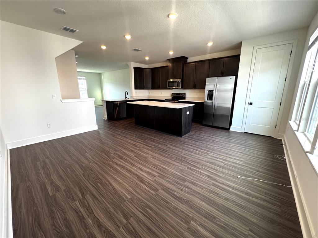 15250 Groveside Road Winter Garden, FL 34787 - Photo 6 of 15 a view of kitchen with sink microwave and refrigerator