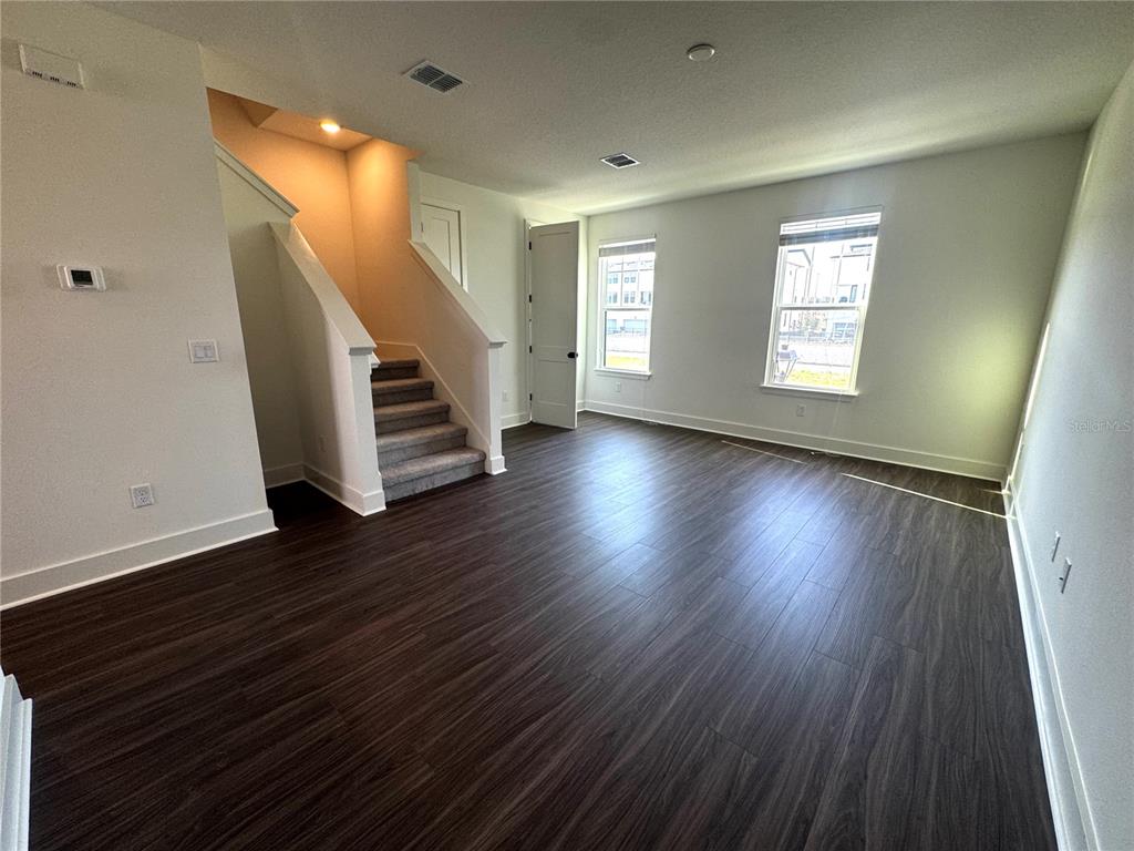 15250 Groveside Road Winter Garden, FL 34787 - Photo 7 of 15 wooden floor in an empty room with a window