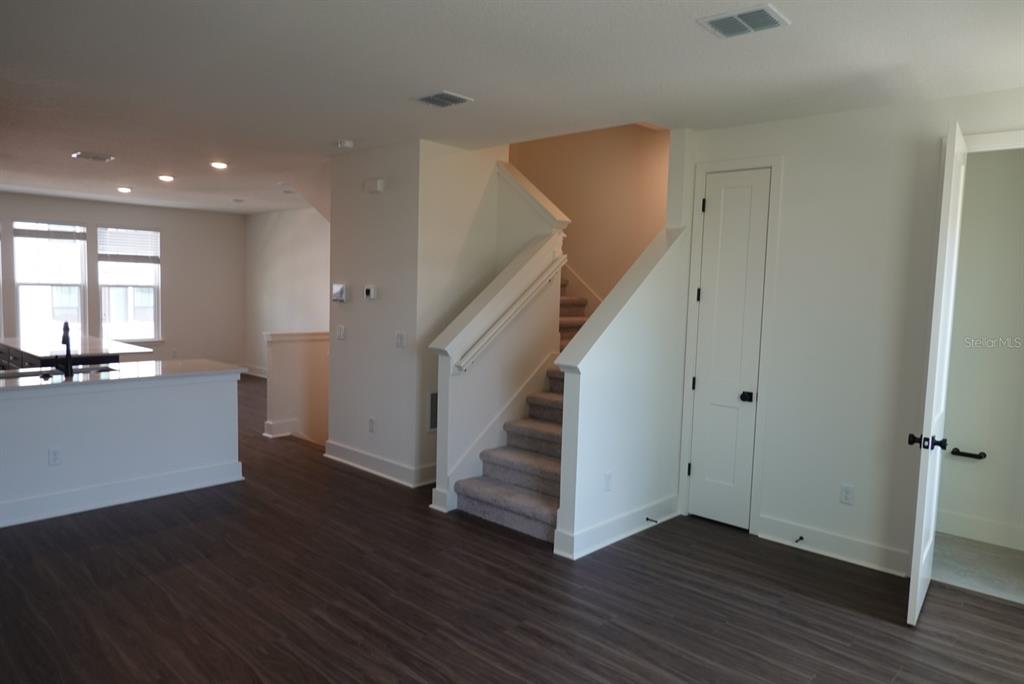 15250 Groveside Road Winter Garden, FL 34787 - Photo 8 of 15 a view of a room with wooden floor and stairs