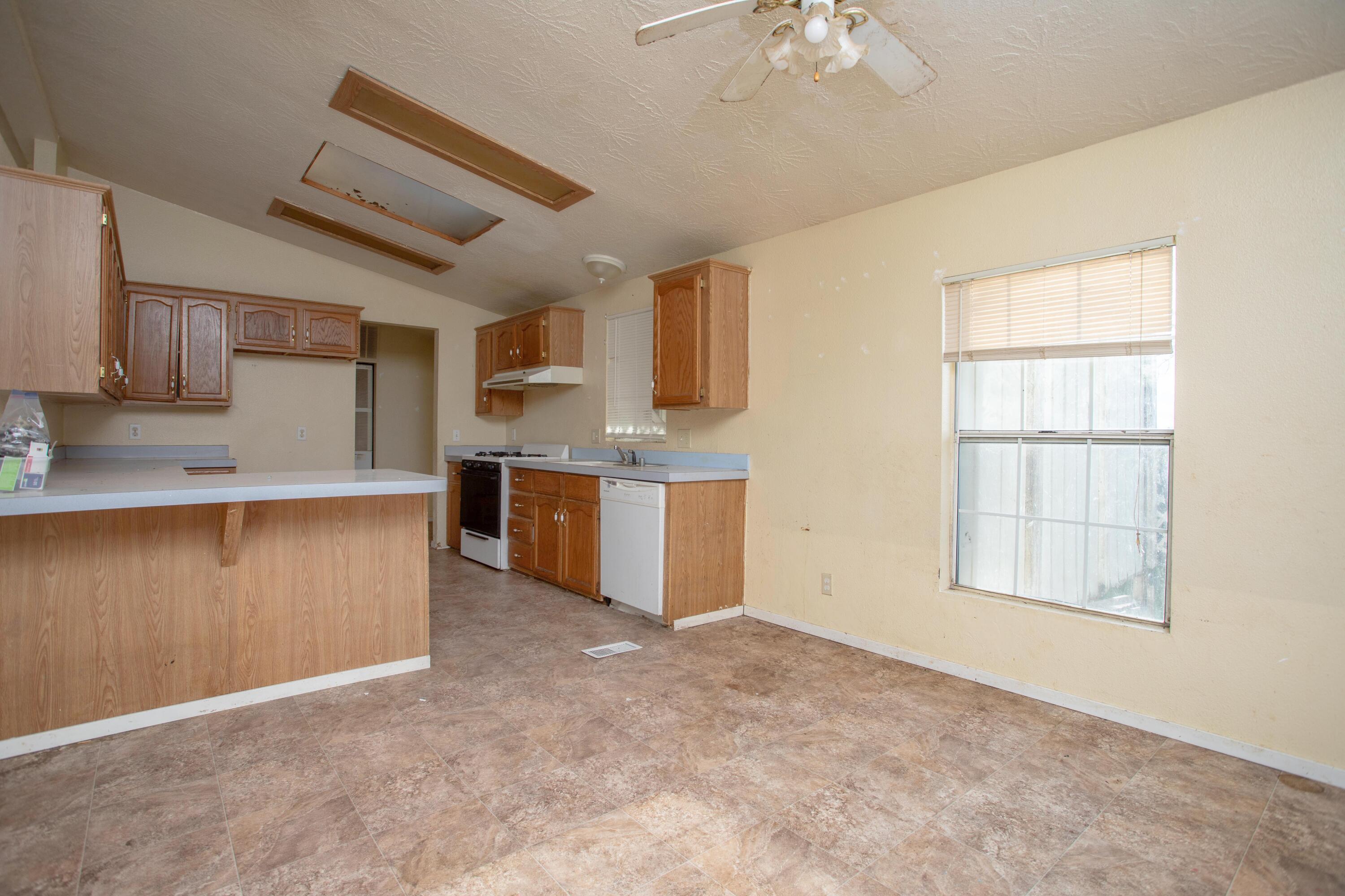 22199 Lone Tree Road Anderson, CA 96007 - Photo 16 of 42 an empty room with a kitchen and a sink
