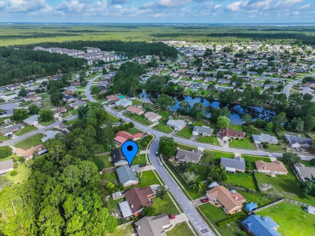an aerial view of a backyard with swimming pool