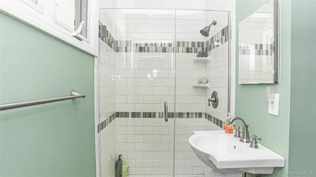a bathroom with a shower and a sink
