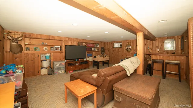 a living room with furniture kitchen view and a large window