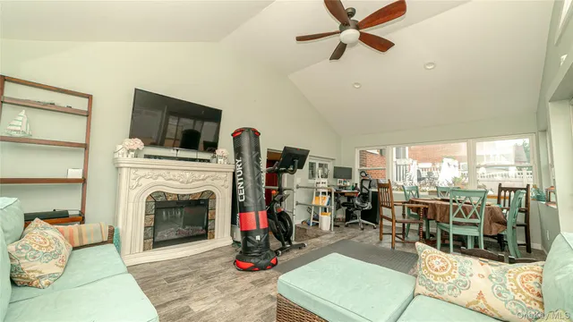 a living room with furniture a flat screen tv and a fireplace