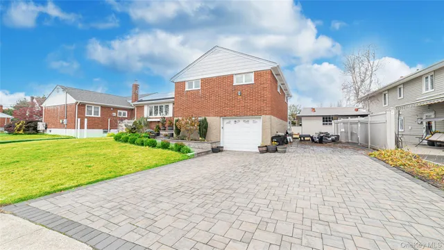 a view of a house with a yard and garage
