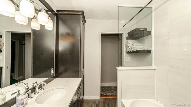 a bathroom with a sink and mirror