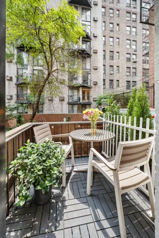 a view of a chair and table in the balcony