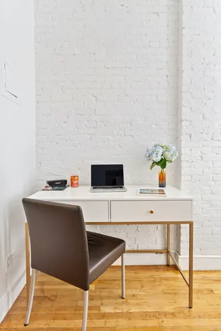 a workspace with furniture and wooden floor