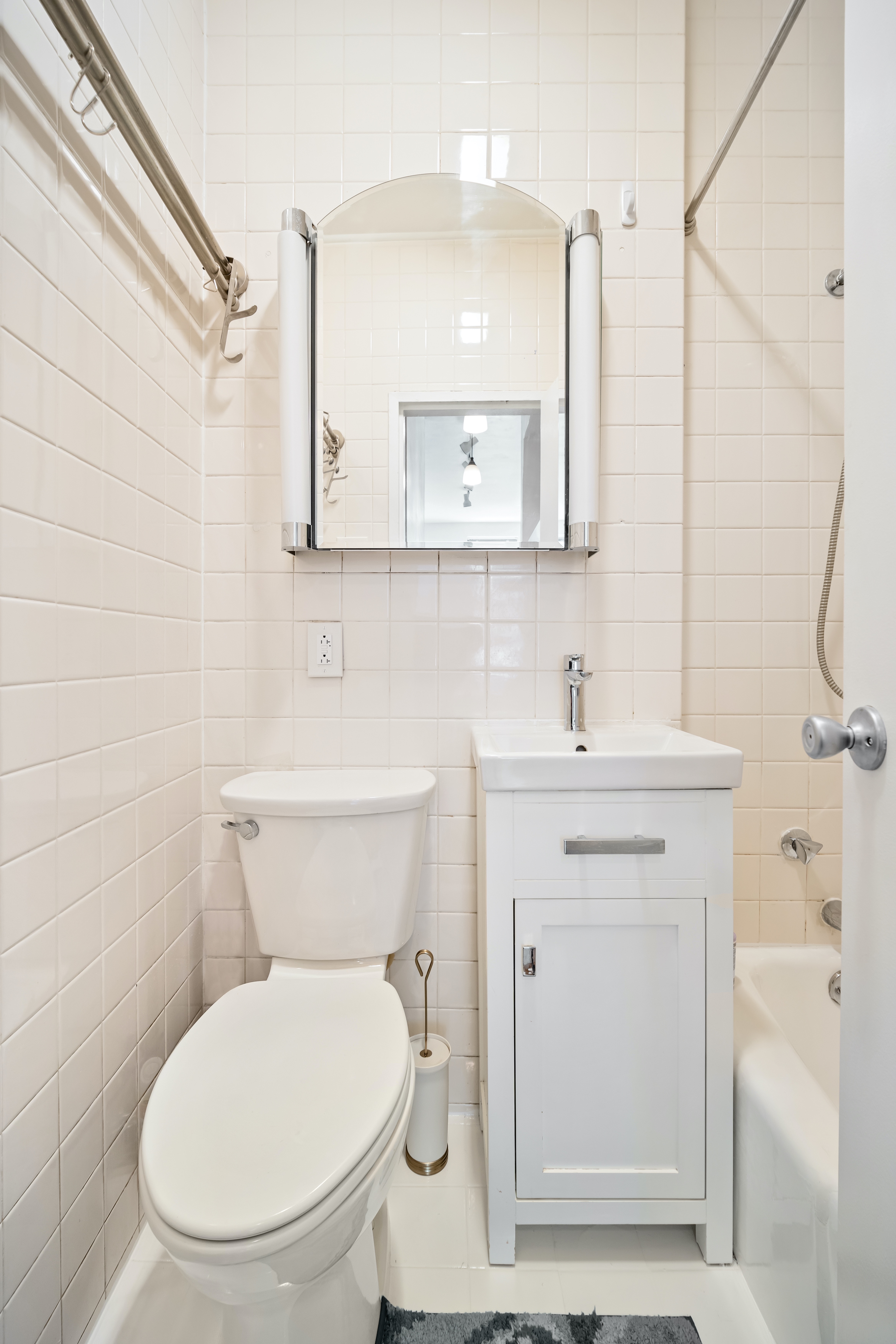 430 East 87th Street, Unit 1B Manhattan, NY 10128 - Photo 4 of 6 a bathroom with a toilet a sink and mirror