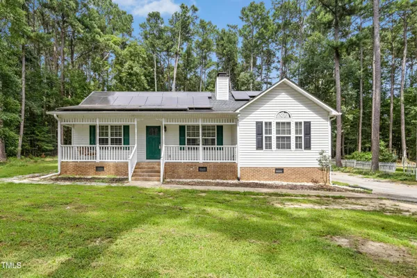 a house that has a big yard in front of it