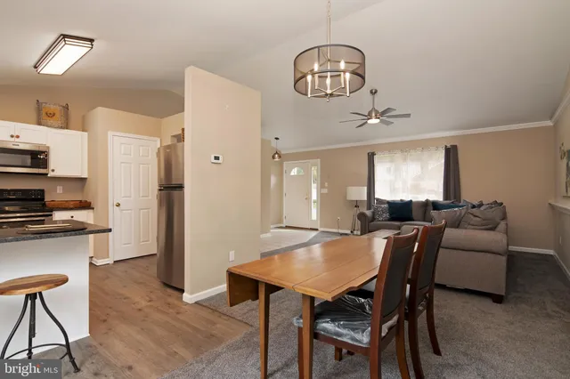 a kitchen with kitchen island granite countertop a sink cabinets and stainless steel appliances
