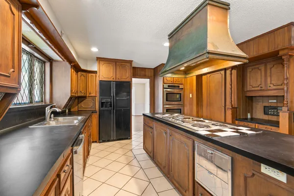 a kitchen with stainless steel appliances a sink stove and refrigerator