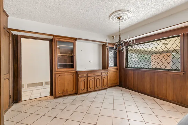 a view of empty room with wooden floor and fireplace
