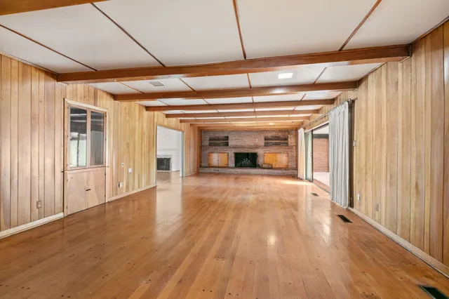 a spacious bathroom with a shower a sink and a mirror