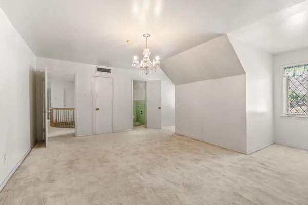 a view of a livingroom with wooden floor and staircase