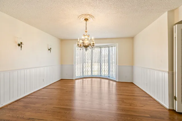 a kitchen with stainless steel appliances granite countertop a stove a sink dishwasher and a refrigerator