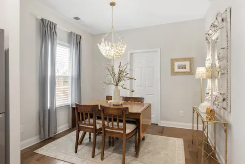 a view of a dining room with furniture and chandelier