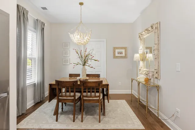 a view of a dining room with furniture and chandelier