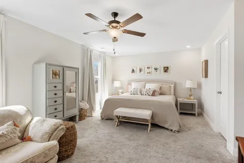 a bedroom with a bed and ceiling fan