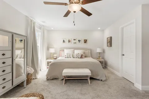 a spacious bedroom with a bed and a chandelier
